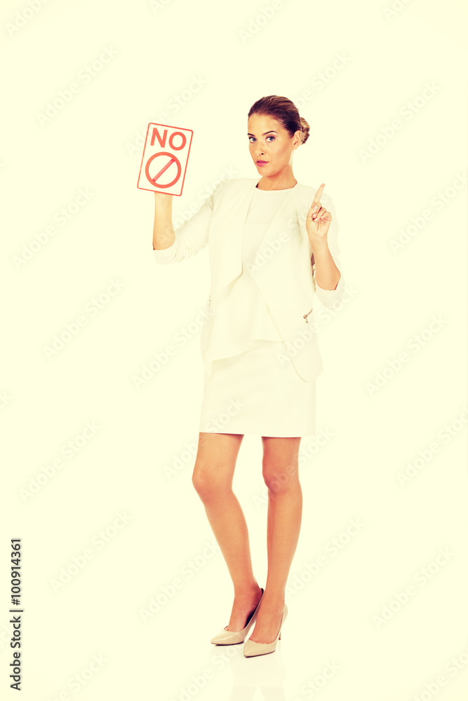 Young businesswoman holding a board with ban Young businesswoman holding a board with ban