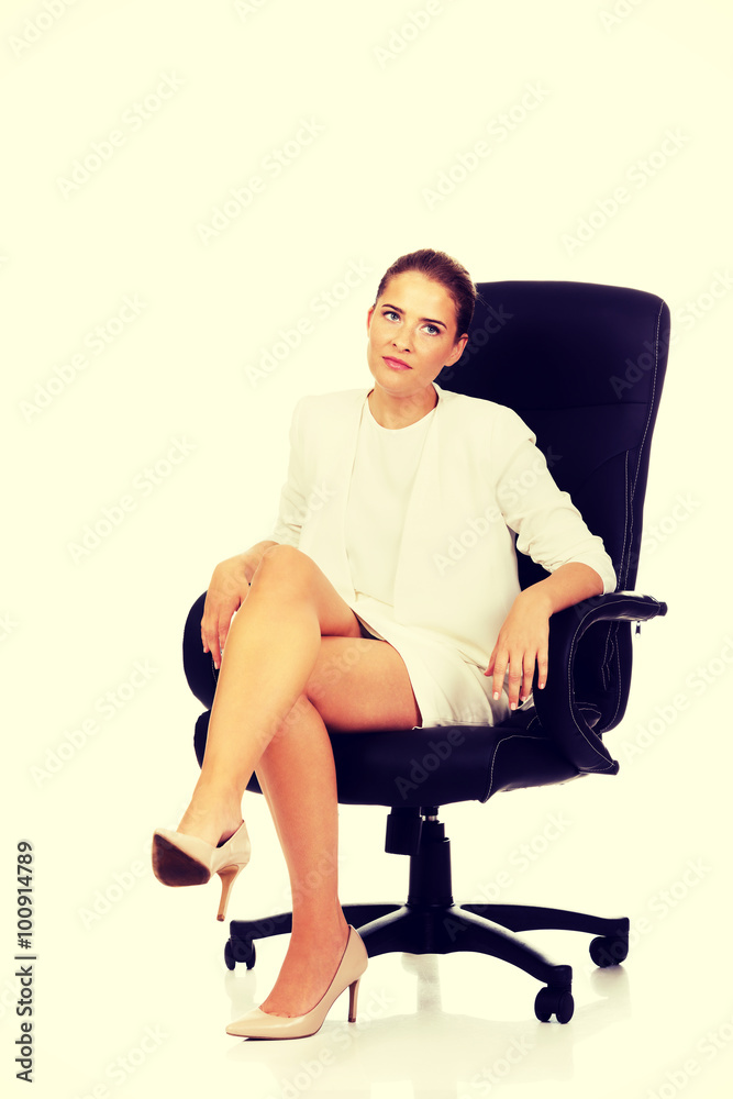 Tired businesswoman sitting on armchair Tired businesswoman sitting on armchair