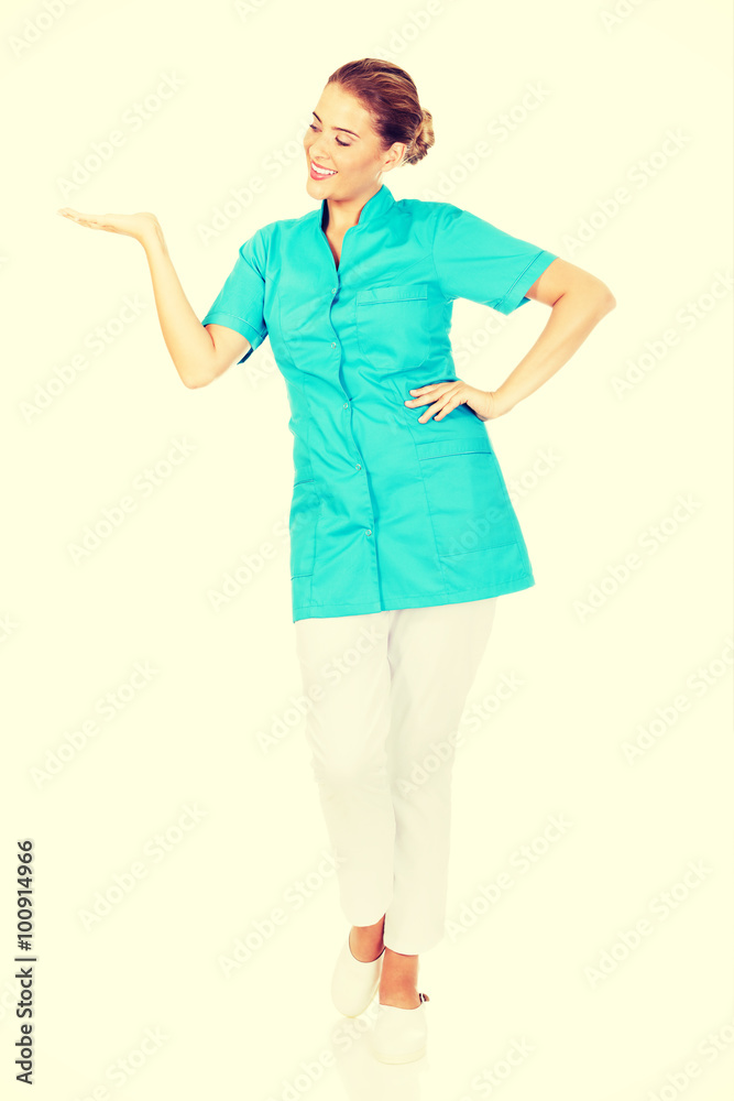 Young female doctor showing something by hand Young female doctor showing something by hand