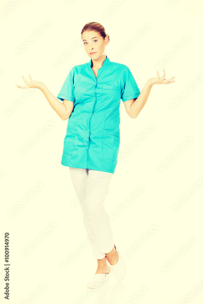 Young female doctor or nurse shrugs Young female doctor or nurse shrugs