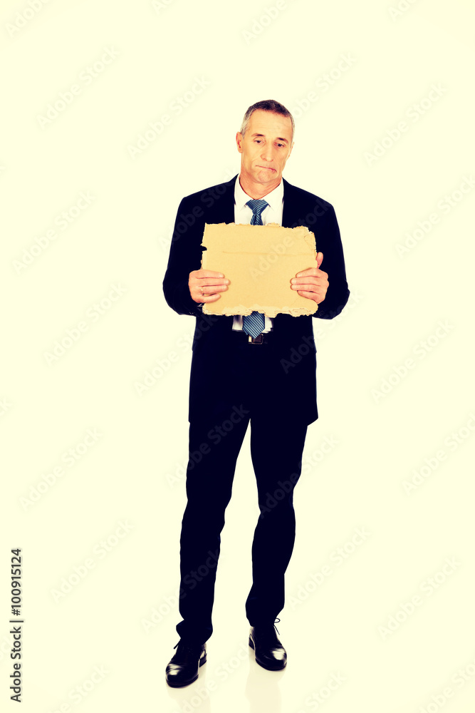 Businessman holding a piece of cardboard Businessman holding a piece of cardboard