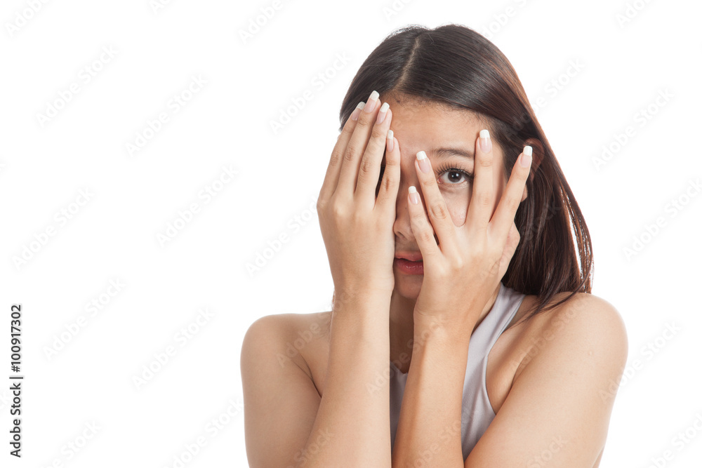 Beautiful young Asian woman peeking through fingers Beautiful young Asian woman peeking through fingers