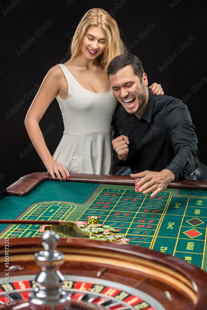 Couple playing roulette wins at the casino. Couple playing roulette wins at the casino.