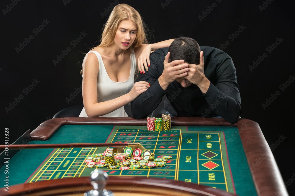 Men with women playing roulette at the casino. Men with women playing roulette at the casino.