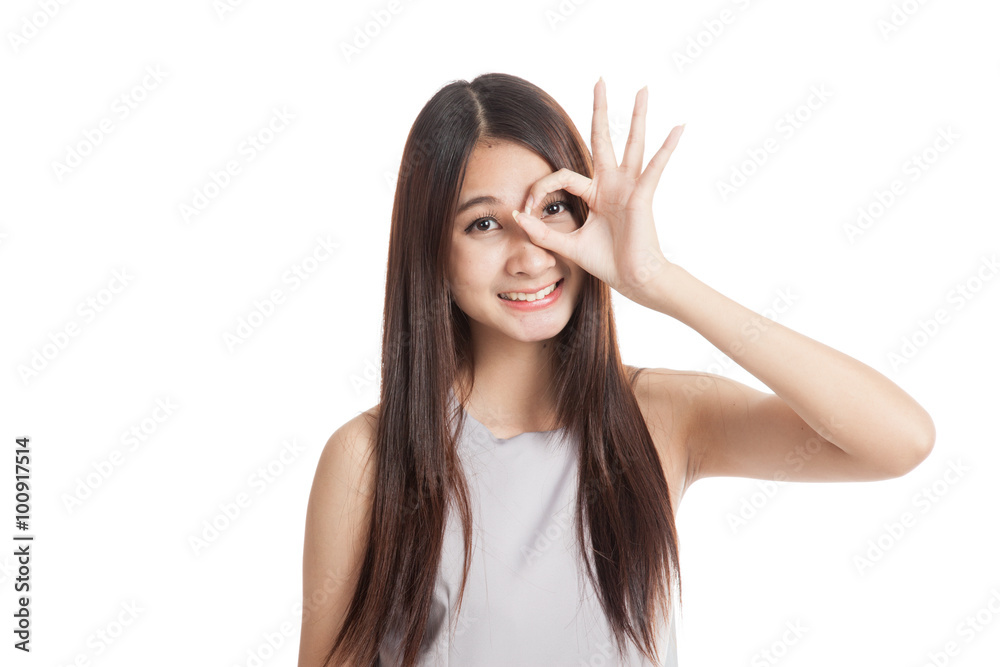 Beautiful young Asian woman show OK sign over her eye Beautiful young Asian woman show OK sign over her eye