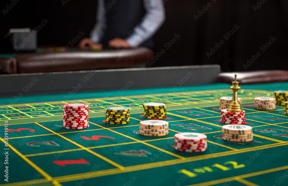 Picture of a green table and betting with chips. Picture of a green table and betting with chips.