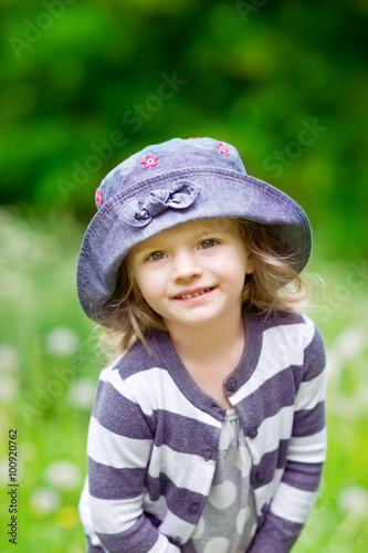 Adorable smiling little girl in summer field