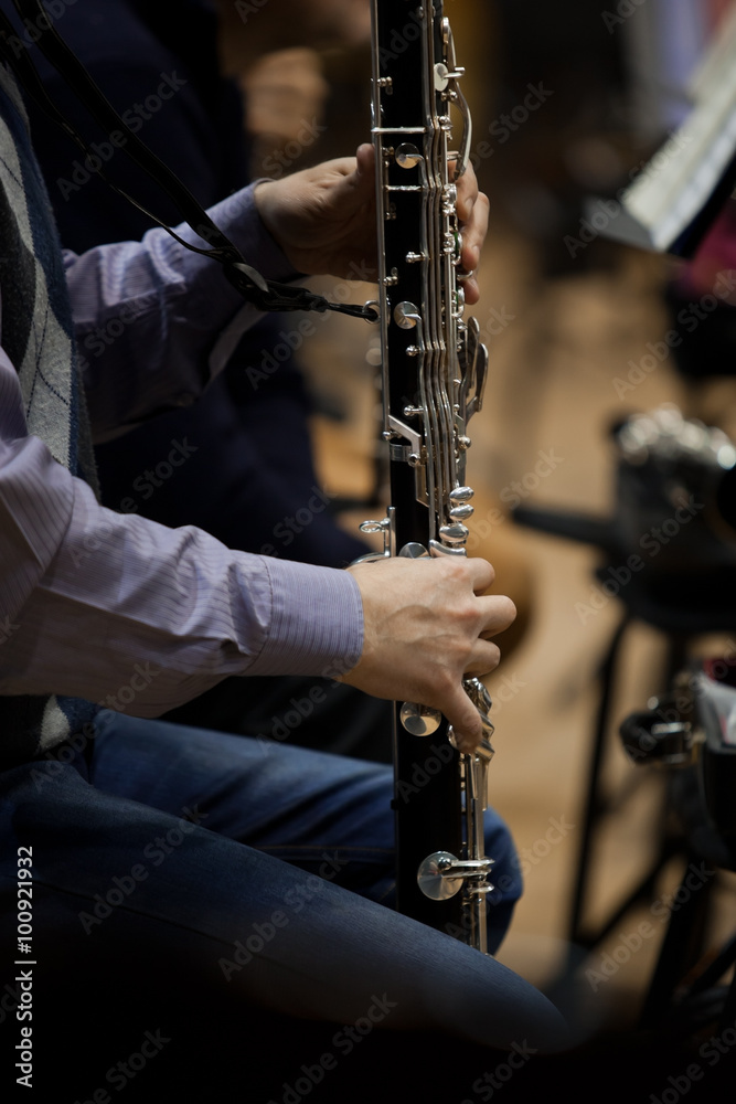 Fototapeta premium Hands musician playing bass clarinet