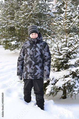 teenage boy at a pine forest in winter