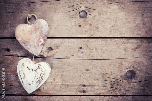 Two  rustic decorative  hearts on vintage wooden background