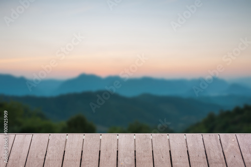 Wood table top on Majestic sunset in the mountains landscape