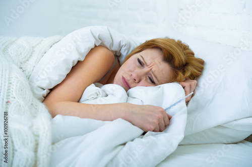 young woman lying in bed sick unable to sleep suffering depress