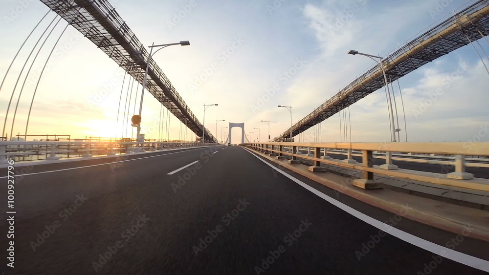 Sunrise drive over the Rainbow Bridge in Tokyo.