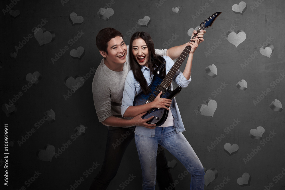 Fototapeta premium Lovely asian couple playing guitar