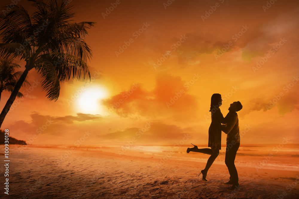 Young couple silhouette on a beach