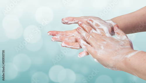 Washing hands. Hygiene concept. Blue bokeh background.