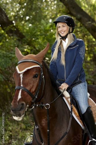 Happy woman horseback riding