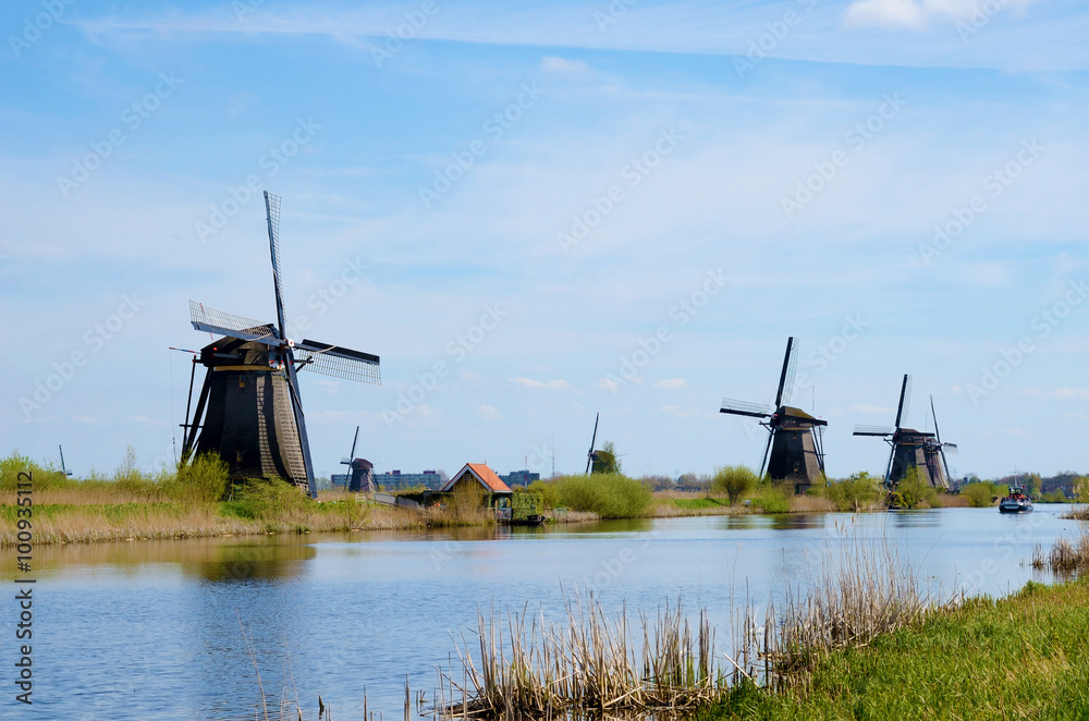 Fantastic landscape with windmills near the river in a Kinderdey