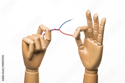 Hands holds an electric wire. Isolated on white background.