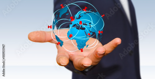 Businessman holding digital world map in his hands