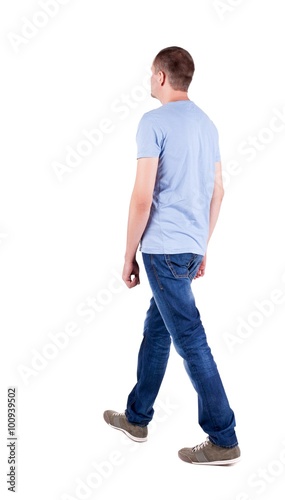 Back view of going handsome man in jeans