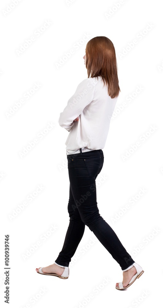 back view of walking woman in jeans. beautiful blonde girl in m back view of walking woman in jeans. beautiful blonde girl in m