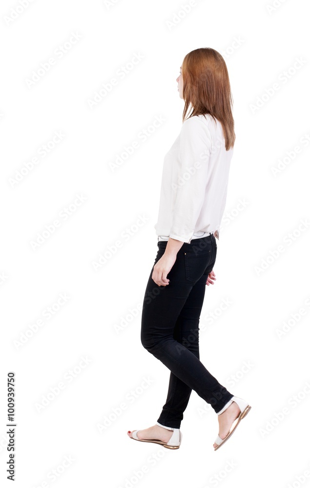 back view of walking woman in jeans. beautiful blonde girl in m back view of walking woman in jeans. beautiful blonde girl in m