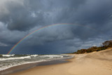 rainbow over the sea and the beach.