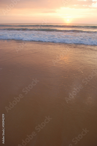 sunset on the smooth sandy beach with white gentle waves  shoot from Phuket island Thailand