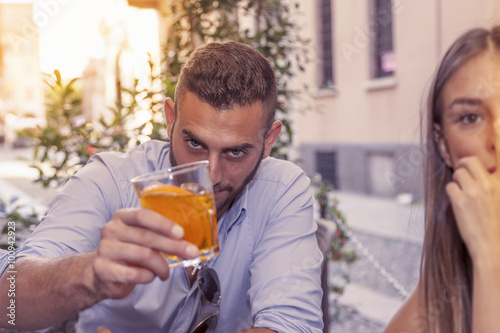 young couple takes a drink in a downtown bar