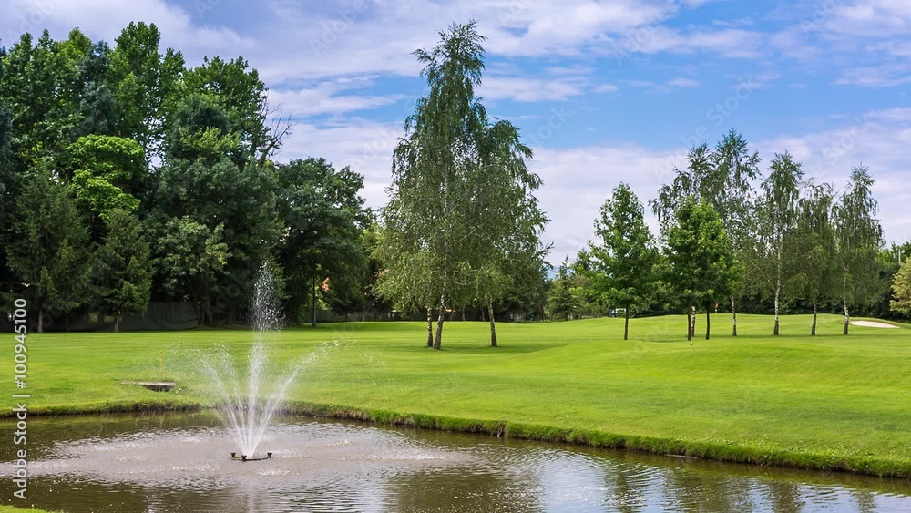 Water fountain sprinkling in an artificial pond at the golf course Water fountain sprinkling in an artificial pond at the golf course