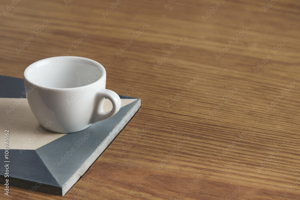Blank white coffee cup on ceramic plate on thick wooden table in Blank white coffee cup on ceramic plate on thick wooden table in