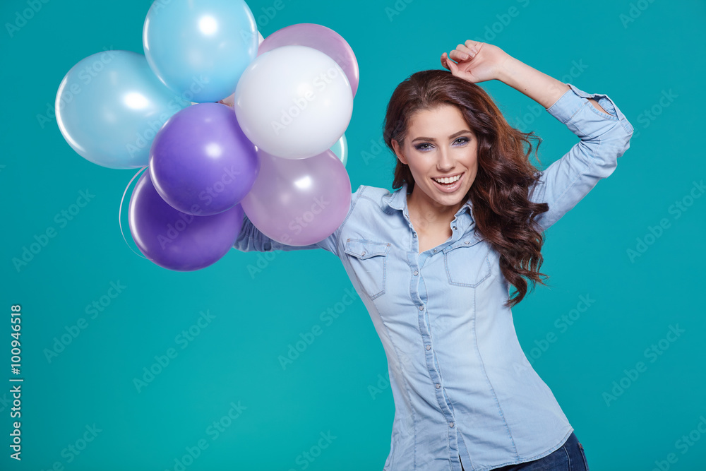 Woman with balloons in studio on a blue background Woman with balloons in studio on a blue background