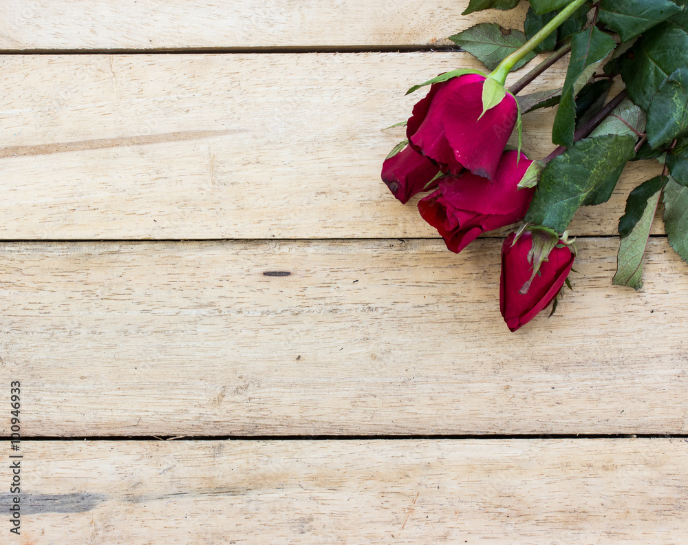 Valentines day background with red roses on wood texture for bac