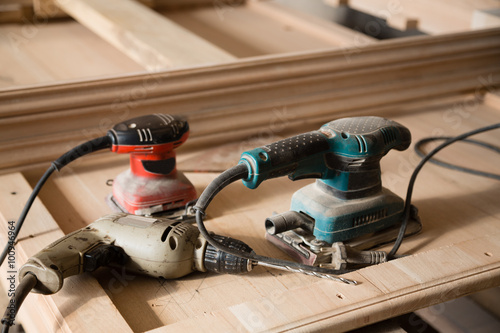 Carpentry tools - hand drill and a sander © Stanislav Komogorov