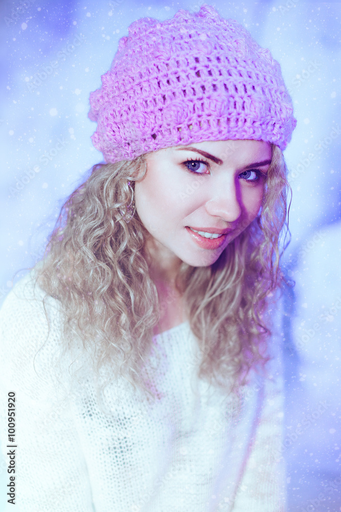 cheerful curly woman in winter hat with christmas lights cheerful curly woman in winter hat with christmas lights