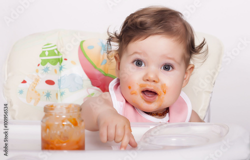 Adorable smudgy baby and favorite baby food in jar