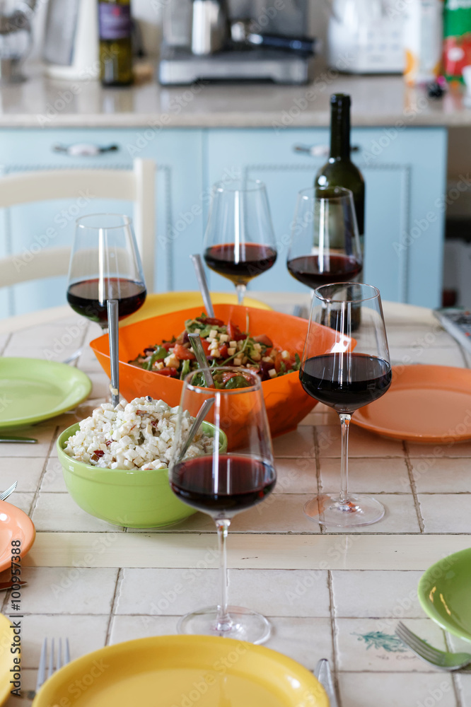 Wine glasses, wine bottle and empty plates on the table