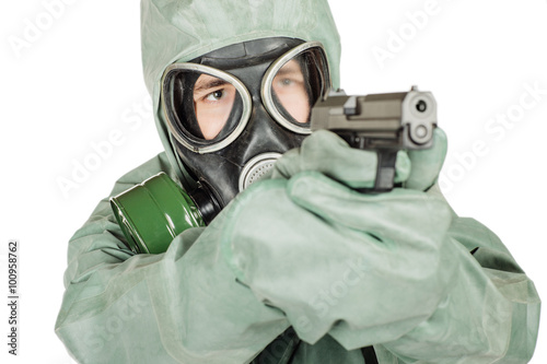 Man with protective mask and protective clothes holding a gun. p