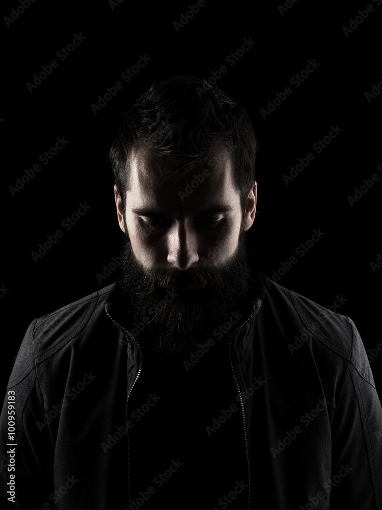 © sharplaninac - Sad bearded man looking down. High contrast low key dark shadow portrait isolated over black background. © sharplaninac - Sad bearded man looking down. High contrast low key dark shadow portrait isolated over black background.