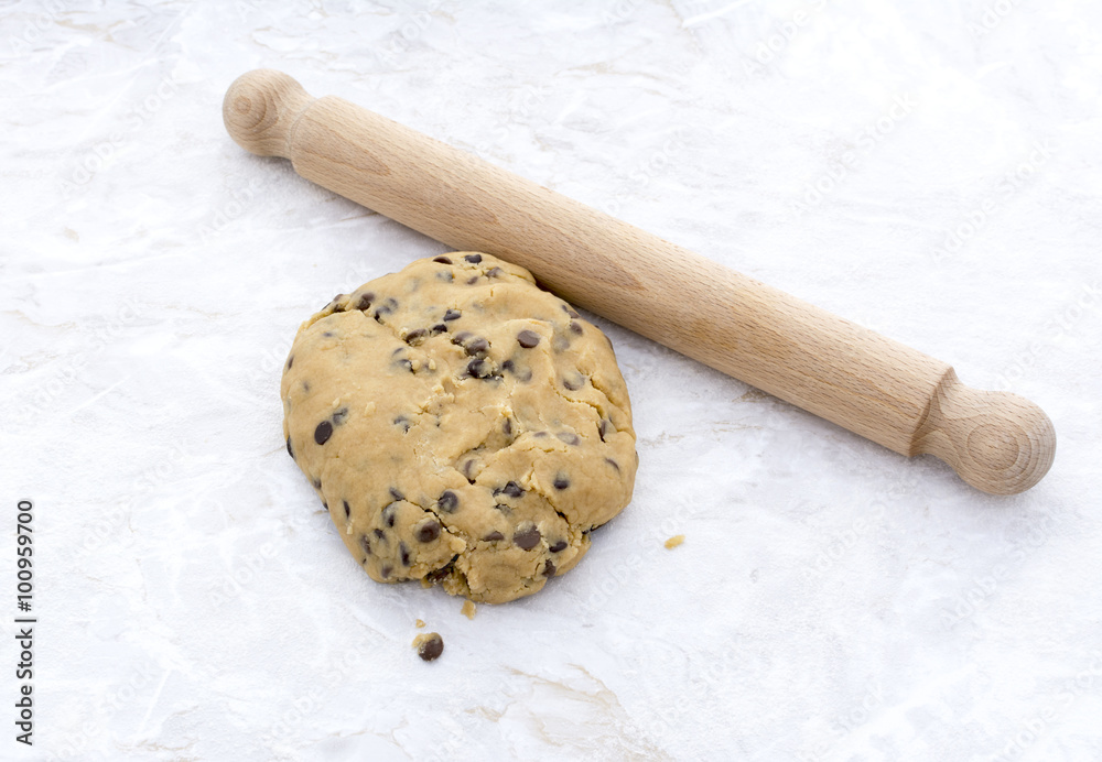 Ball of chocolate chip cookie dough with rolling pin Ball of chocolate chip cookie dough with rolling pin