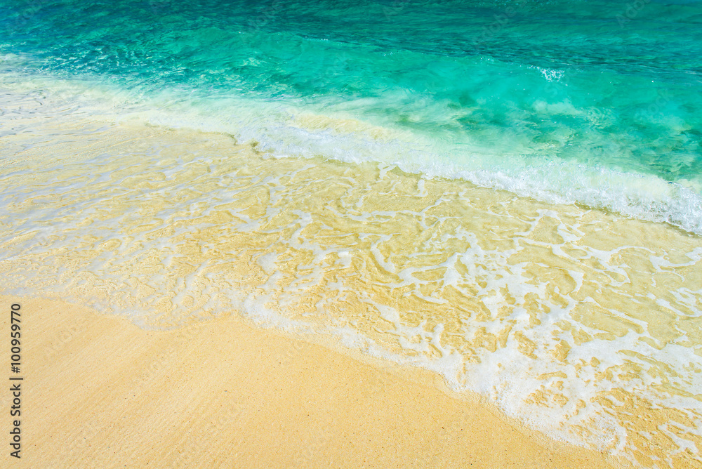Soft wave of the turquoise sea on the sandy beach. Natural summe