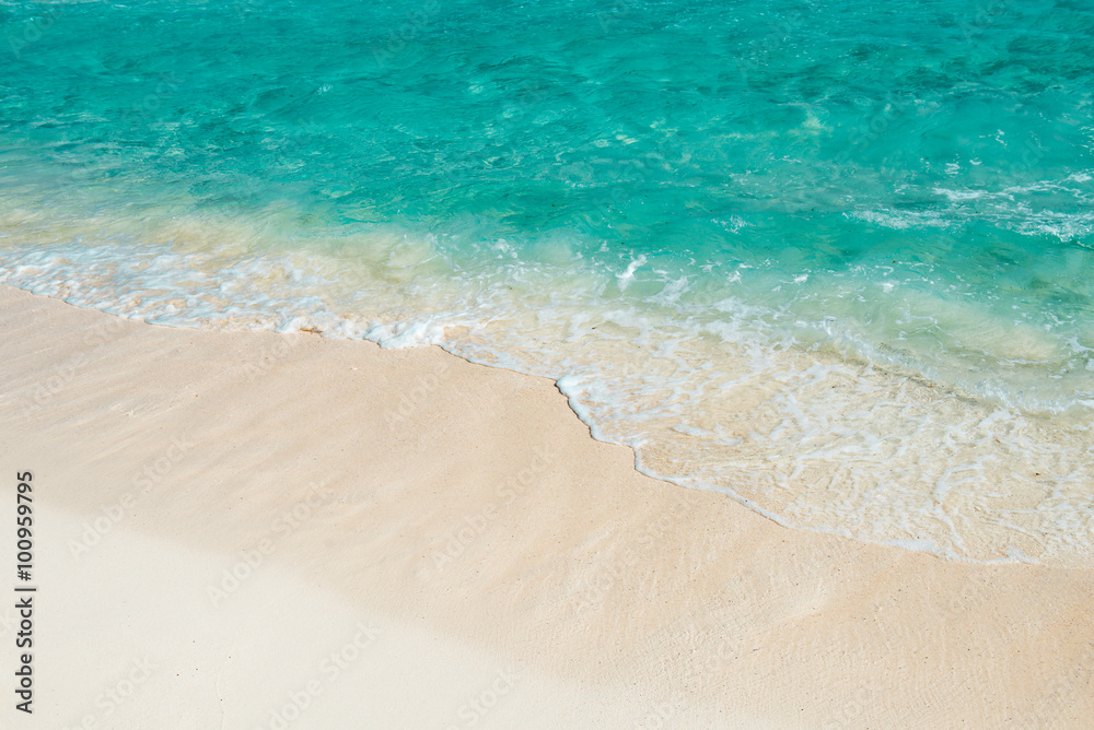 Soft wave of the turquoise sea on the sandy beach. Natural summe