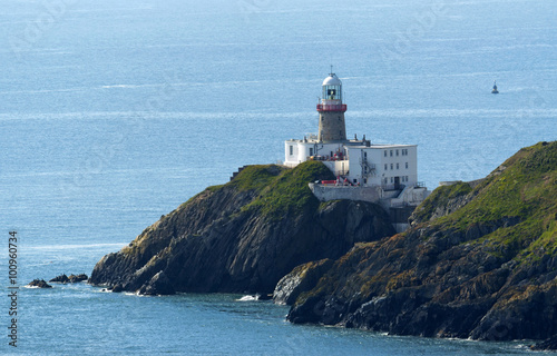 Cliffs in Howth and lighthouse, Ireland photo