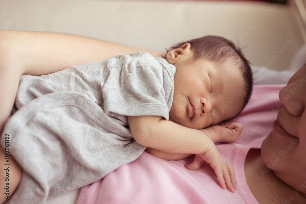 Asian mother holds her newborn baby Asian mother holds her newborn baby