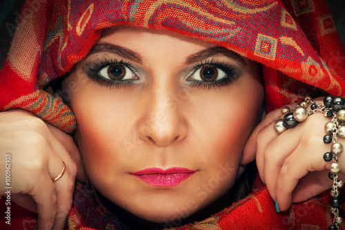 Portrait of a beautiful oriental woman in a traditional headscar photo
