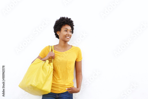Beautiful young woman with a handbag looking at copy space