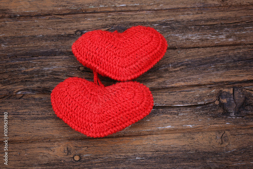 pair of knitted hearts on old wooden background Valentine s Day love handmade