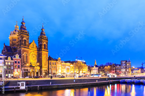 Night city view of Amsterdam canal and Basilica of Saint Nichola