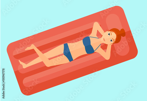 Woman relaxing in swimming pool.